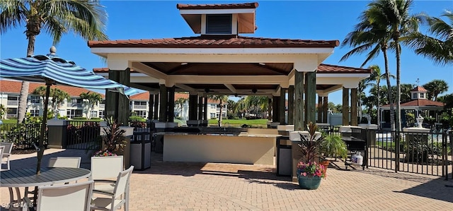 23861 Costa Del Sol Rd Unit 203, Estero, FL 34135 - view of patio with a bar, a gazebo, exterior kitchen, and ceiling fan