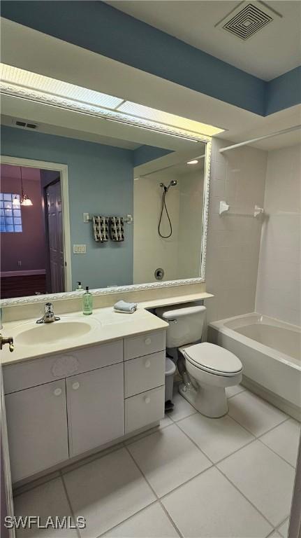 23861 Costa Del Sol Rd Unit 203, Estero, FL 34135 - bathroom featuring toilet, tile patterned flooring, vanity, and shower / washtub combination