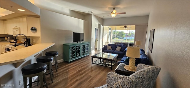 23861 Costa Del Sol Rd Unit 203, Estero, FL 34135 - living area featuring a ceiling fan, dark wood-style flooring, and baseboards