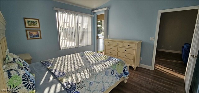 23861 Costa Del Sol Rd Unit 203, Estero, FL 34135 - bedroom with dark wood finished floors and baseboards