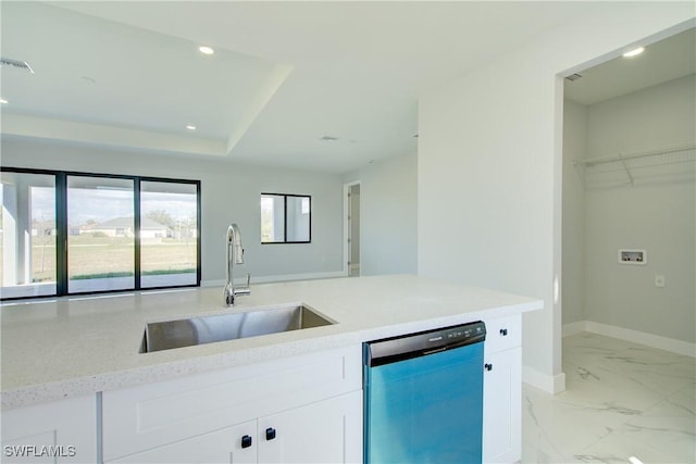 kitchen featuring dishwashing machine, sink, light stone counters, white cabinets, and a raised ceiling