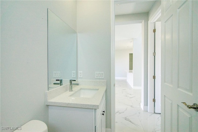 bathroom featuring vanity and toilet