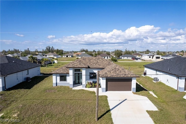 view of front of property featuring a garage and a front lawn