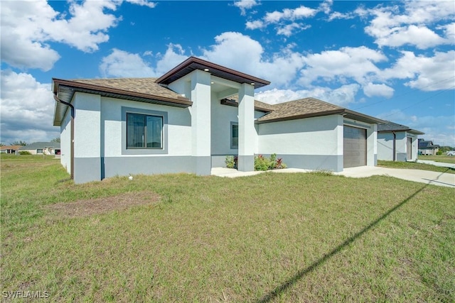 view of front of home featuring a garage and a front lawn