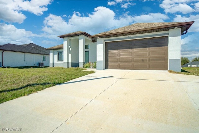 view of front of house with cooling unit, a garage, and a front lawn