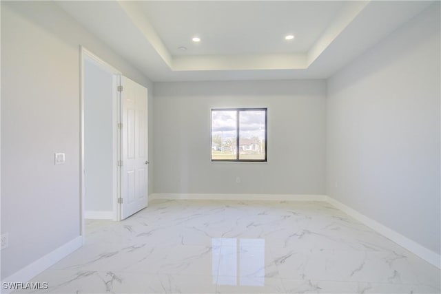 spare room featuring a tray ceiling