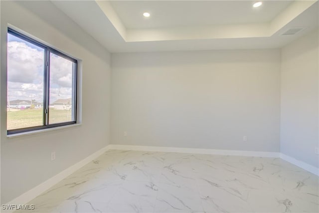 empty room with a raised ceiling