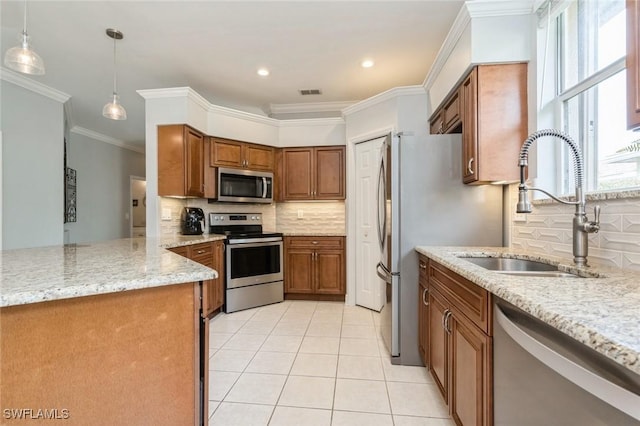 kitchen with hanging light fixtures, stainless steel appliances, light stone counters, light tile patterned floors, and sink