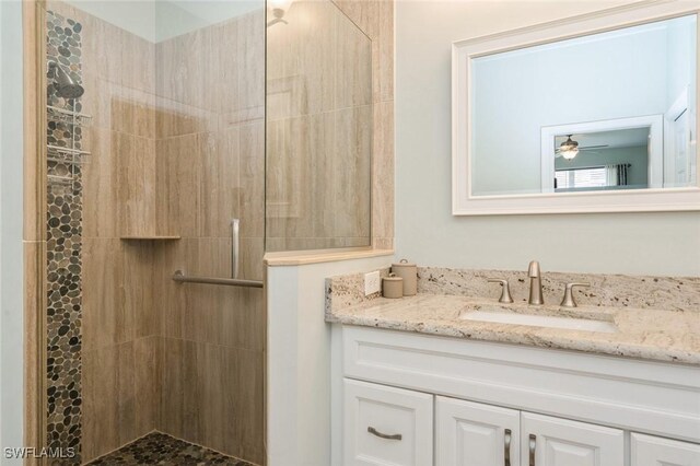 2291 Granby Dr, Lehigh Acres, FL 33973 - bathroom featuring vanity, ceiling fan, and tiled shower
