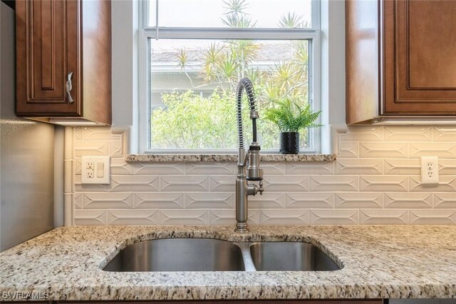 2291 Granby Dr, Lehigh Acres, FL 33973 - kitchen with a sink, tasteful backsplash, and light stone countertops