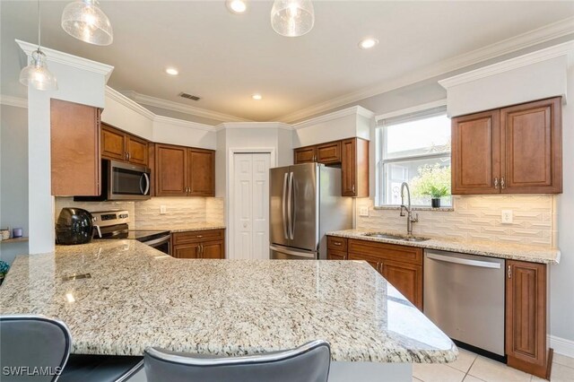 2291 Granby Dr, Lehigh Acres, FL 33973 - kitchen with visible vents, brown cabinetry, a peninsula, a sink, and appliances with stainless steel finishes