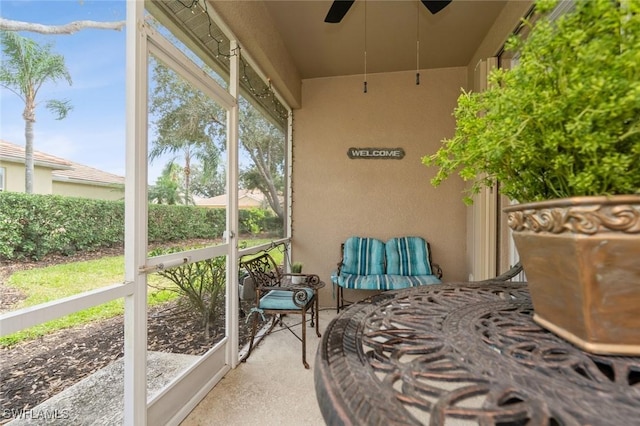 sunroom featuring ceiling fan