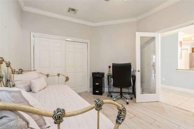 bedroom featuring light wood-type flooring, french doors, stainless steel fridge, a closet, and crown molding