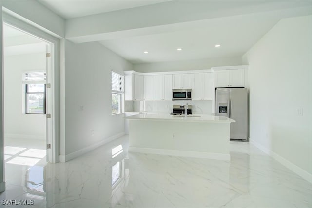 kitchen with white cabinetry, sink, an island with sink, and appliances with stainless steel finishes