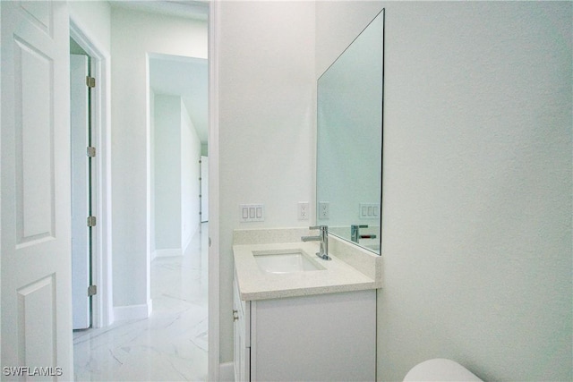 bathroom featuring vanity and toilet