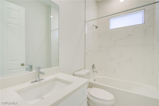 full bathroom featuring tiled shower / bath, vanity, and toilet