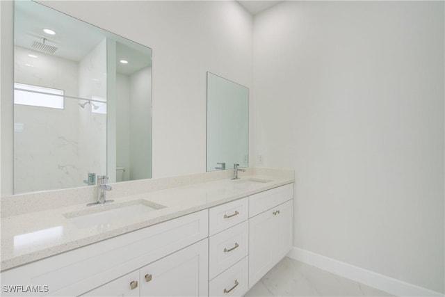 bathroom featuring vanity, toilet, and walk in shower