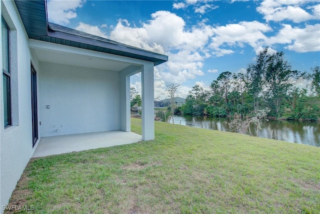 view of yard with a patio and a water view