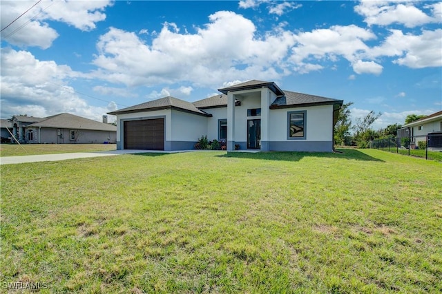 view of front of property featuring a garage and a front yard