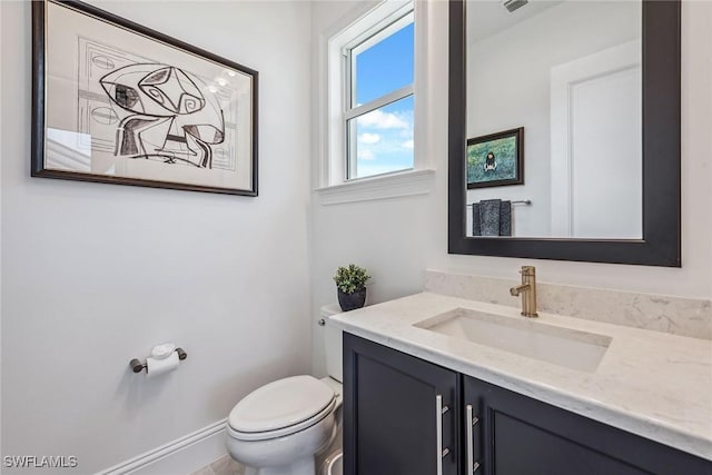 bathroom featuring toilet, visible vents, and vanity