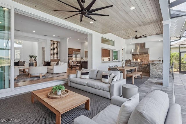 living room with recessed lighting, wood ceiling, and a ceiling fan