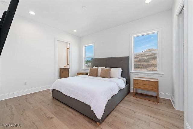 bedroom with light wood-style floors, baseboards, and recessed lighting