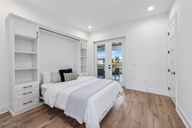 bedroom with light wood finished floors, access to outside, baseboards, and french doors