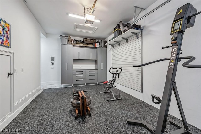 workout room with a garage and baseboards