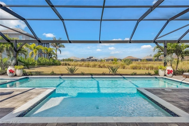 outdoor pool featuring a lanai and a patio area