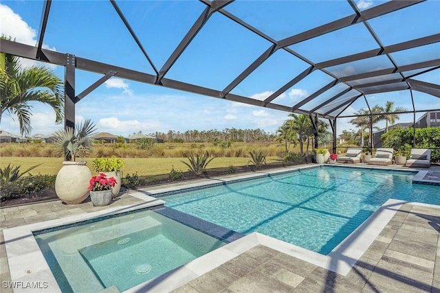 view of pool featuring a pool with connected hot tub, a lanai, and a patio