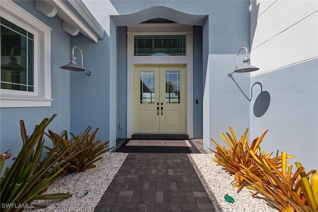 property entrance with stucco siding