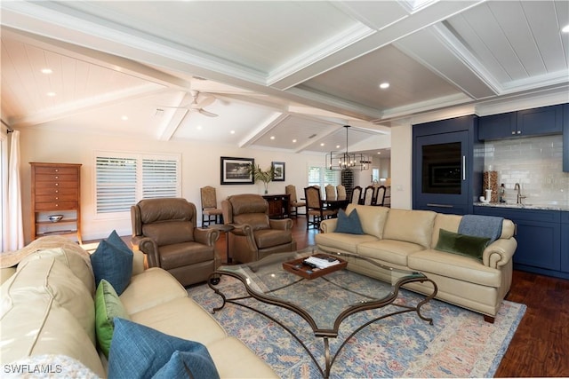 living room with recessed lighting, dark wood-style floors, vaulted ceiling with beams, crown molding, and ceiling fan with notable chandelier