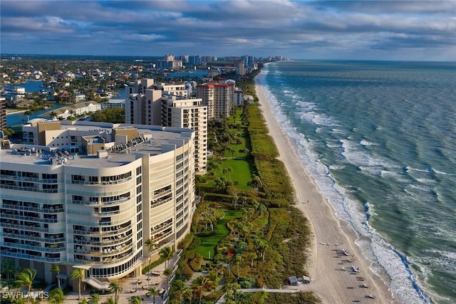 drone / aerial view featuring a water view and a beach view