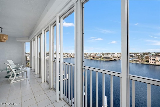 unfurnished sunroom featuring a water view