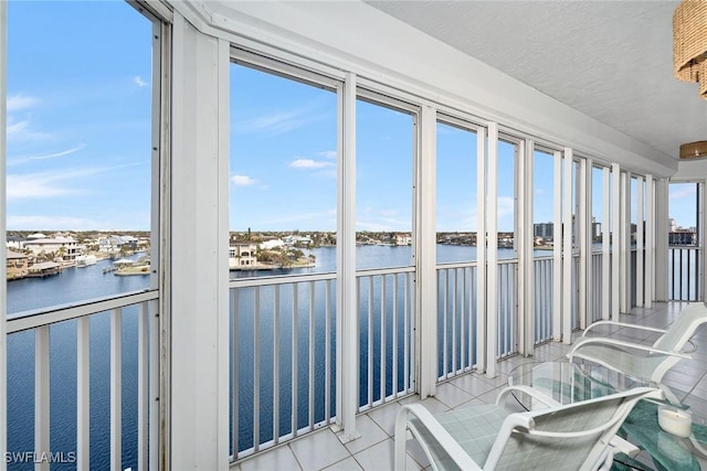 unfurnished sunroom with a water view