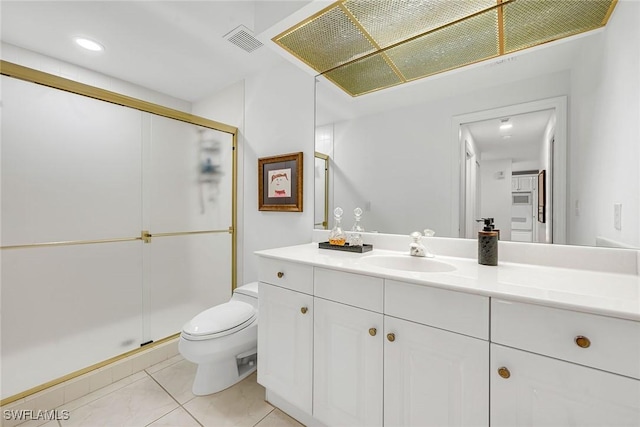 bathroom featuring vanity, toilet, a shower with shower door, and tile patterned flooring