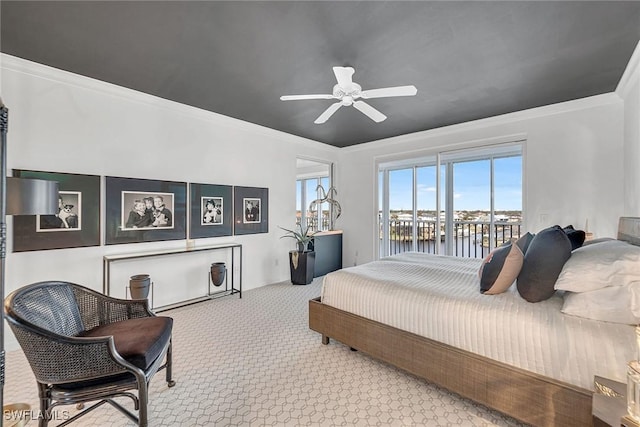 bedroom with carpet floors, access to outside, ornamental molding, and a water view