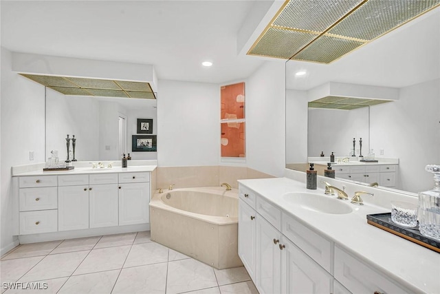 bathroom with vanity, a washtub, and tile patterned floors