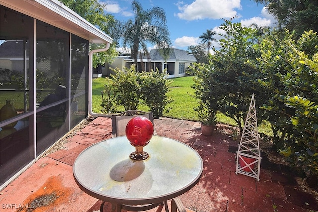 view of patio featuring a sunroom