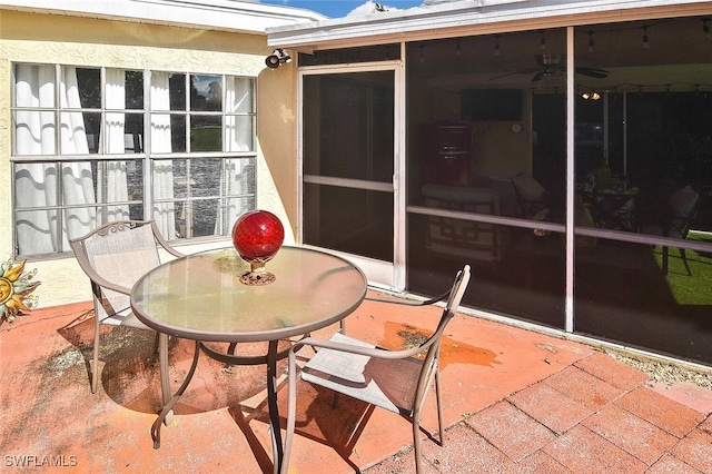 4 Park Lane Cir, Lehigh Acres, FL 33936 - view of patio featuring outdoor dining area, a sunroom, and ceiling fan
