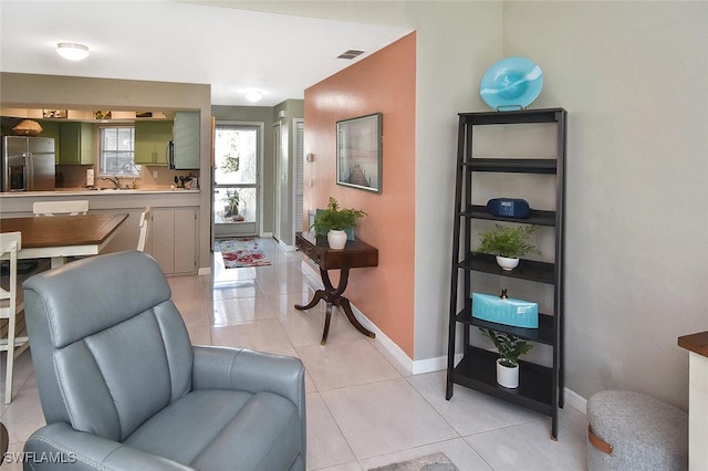 interior space featuring light tile patterned flooring, visible vents, and baseboards