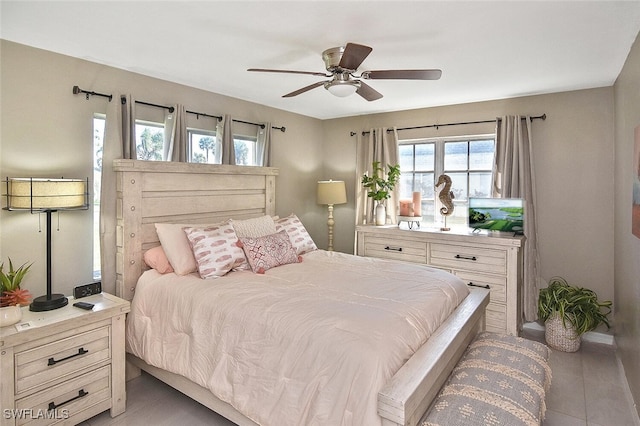 4 Park Lane Cir, Lehigh Acres, FL 33936 - bedroom featuring light tile patterned floors, multiple windows, and a ceiling fan