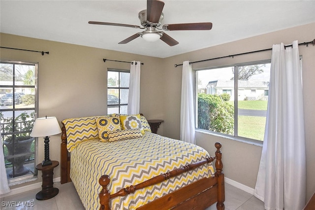 4 Park Lane Cir, Lehigh Acres, FL 33936 - tiled bedroom featuring baseboards and ceiling fan