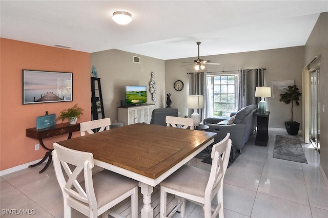 dining room with light tile patterned floors, ceiling fan, visible vents, and baseboards