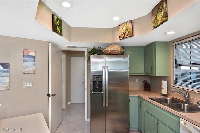 kitchen featuring green cabinets, stainless steel refrigerator with ice dispenser, a sink, and dishwasher