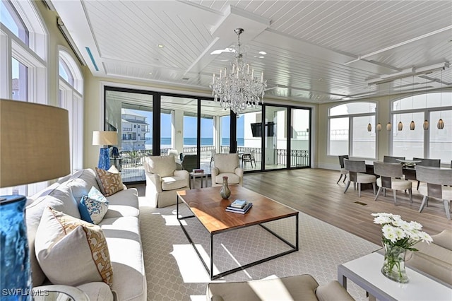 104 Bonaire Ln, Bonita Springs, FL 34134 - living room with a notable chandelier and wood finished floors