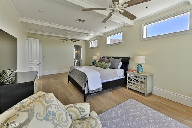 bedroom featuring ornamental molding, wood finished floors, visible vents, and baseboards