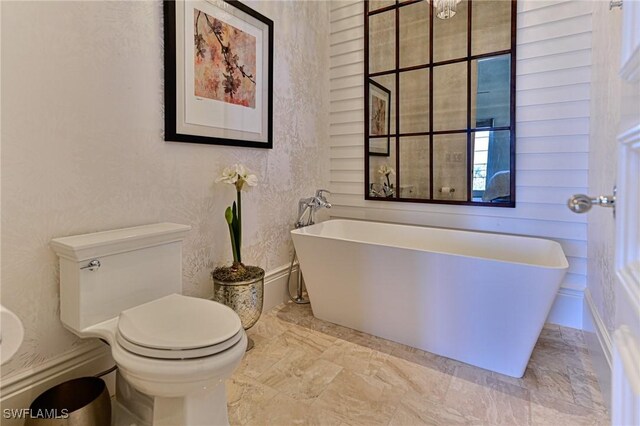 104 Bonaire Ln, Bonita Springs, FL 34134 - bathroom with toilet and a soaking tub