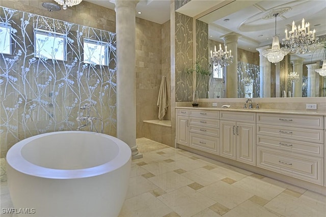 104 Bonaire Ln, Bonita Springs, FL 34134 - bathroom with a soaking tub, a wealth of natural light, an inviting chandelier, and ornate columns