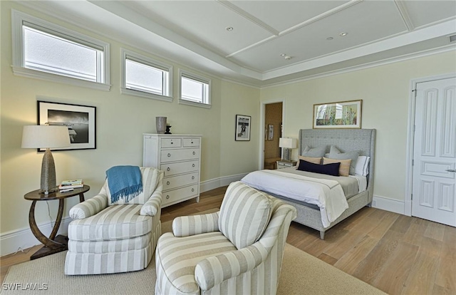 bedroom with visible vents, baseboards, and wood finished floors